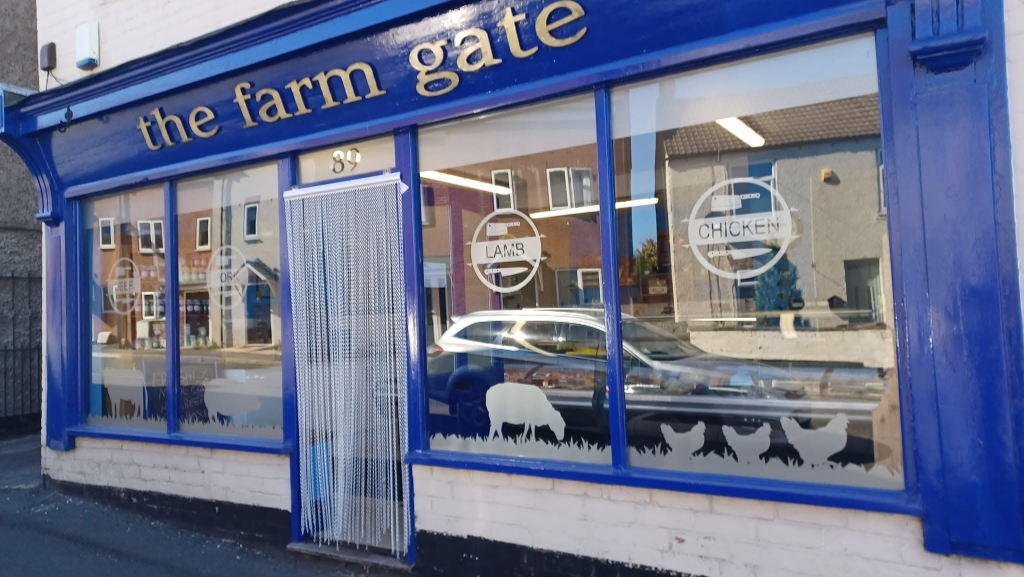 The Farm Gate butcher shop front on Wharf Road, Pinxton — a traditional blue-fronted shop with gold lettering